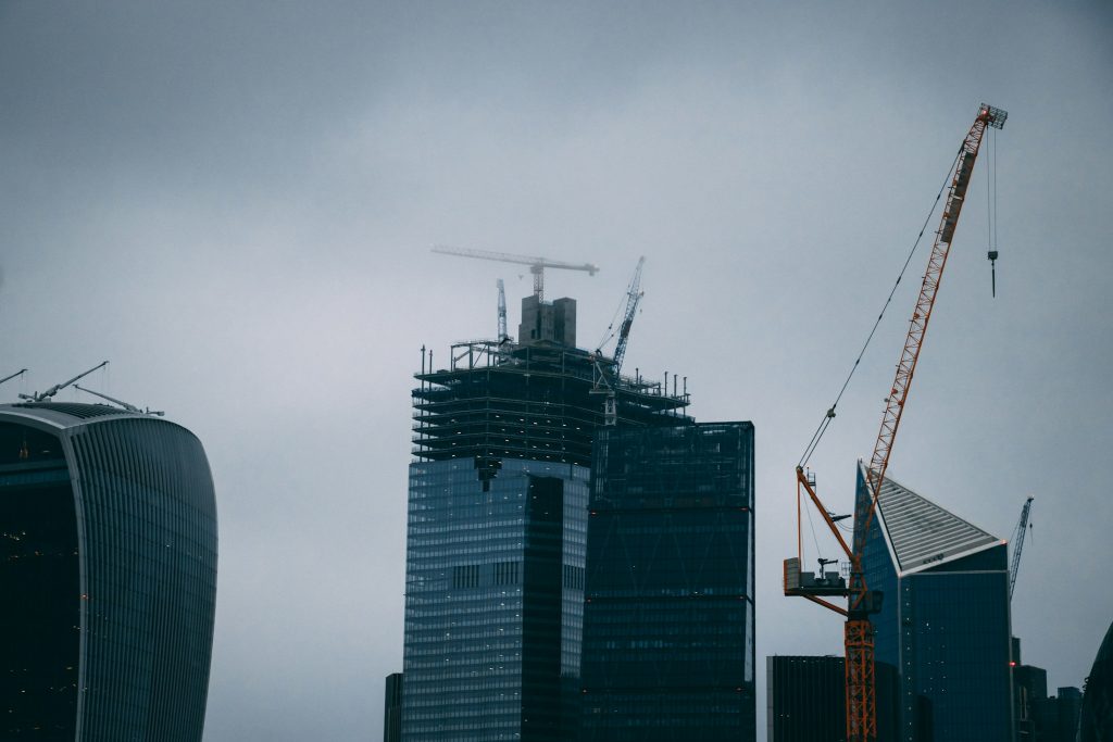 Tower crane beside a glass office building under construction in London
